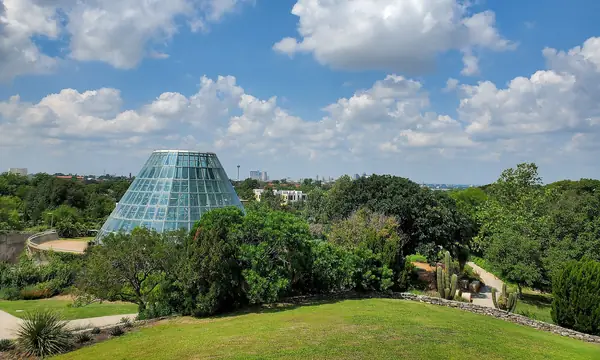 Green lawns and the glass conservatory at the San Antonio Botanical Garden, Texas