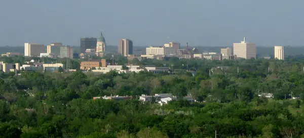 Topeka, Kansas, skyline rising above green trees