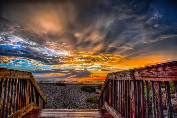 Sunset over the beach and a wooden boardwalk on the Florida coast